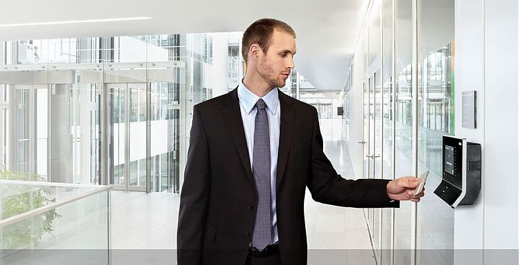 a man in a suit and tie holding a card for access control system