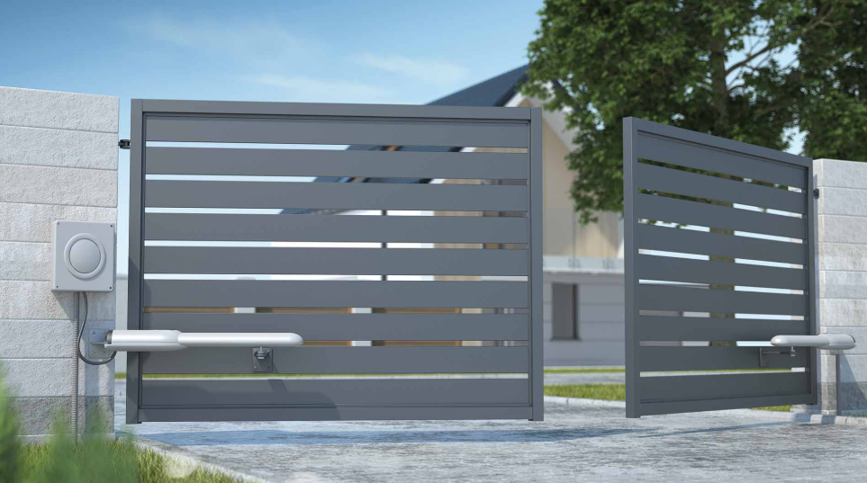 a pair of automatic gates that are next to a house